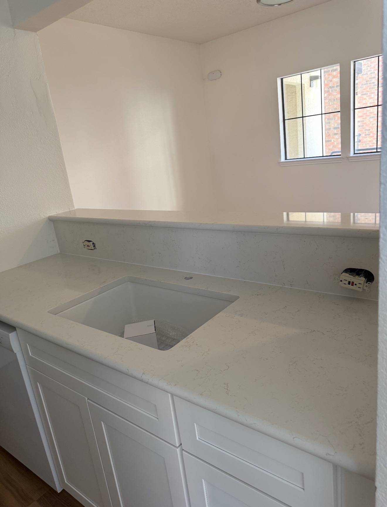 White kitchen cabinetry and installed stone countertop